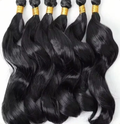 Six black body wave hair bundles arranged together